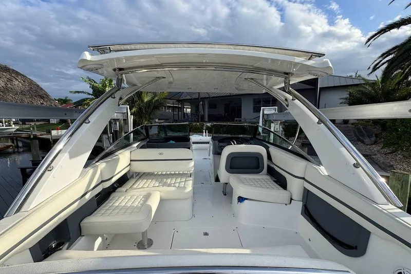 Slide: The Image of 2018 Cobalt 30SC boat interior with white seating, sleek design, and open canopy. - 16
