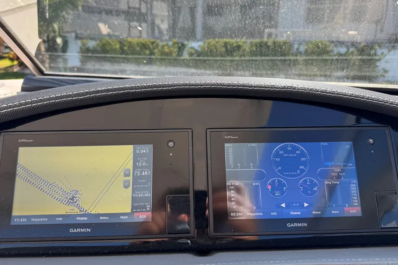Slide: The Image of Garmin GPS displays on 2018 Cobalt 30SC boat dashboard, showing navigation and engine data. - 22