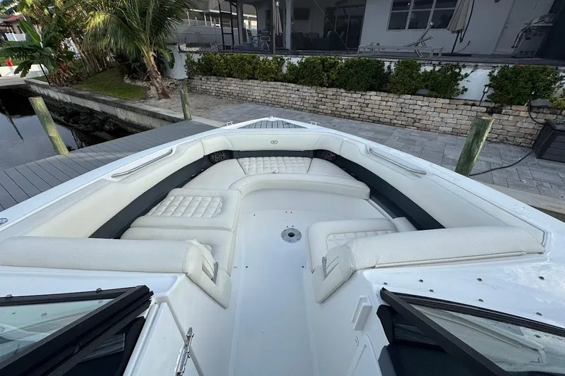 Slide: The Image of 2018 Cobalt 30SC boat with spacious white seating area at dockside. - 26