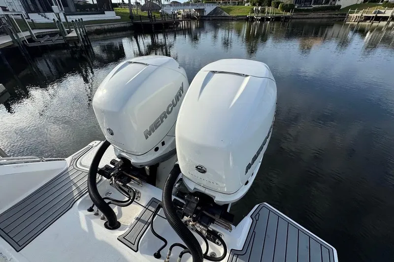 Slide: The Image of 2018 Cobalt 30SC boat with dual Mercury outboard engines on a calm waterway. - 29