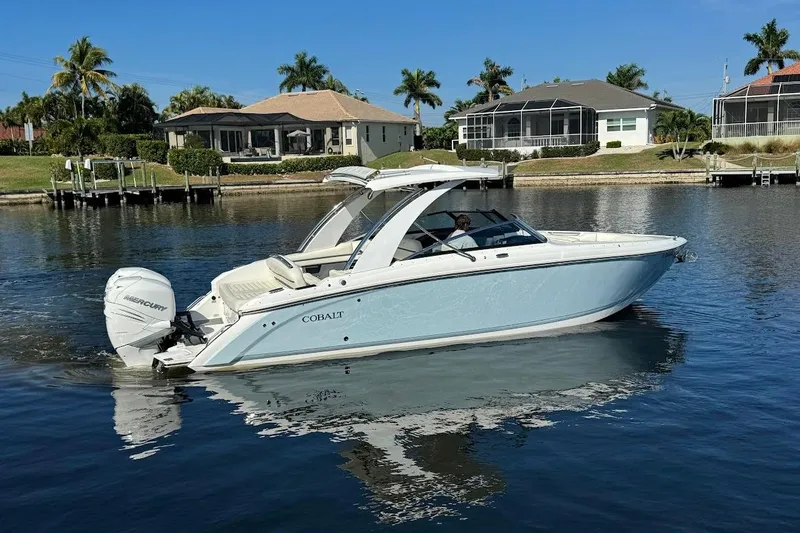 Slide: The Image of 2018 Cobalt 30SC boat on calm water near waterfront homes. - 3