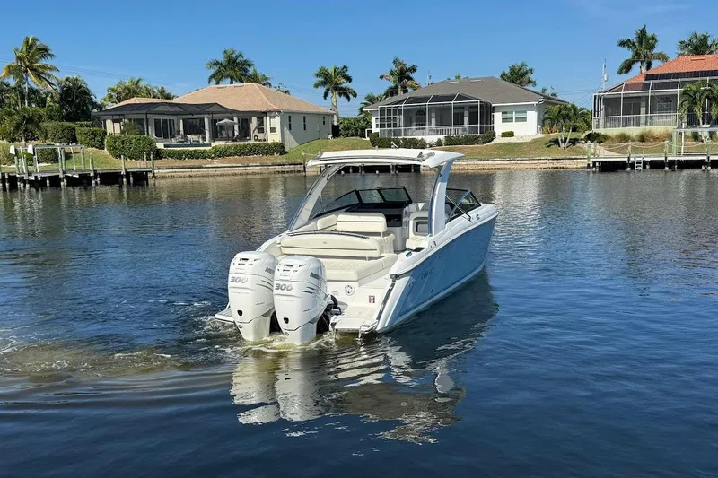 Slide: The Image of 2018 Cobalt 30SC boat with dual engines on a calm waterfront. - 5