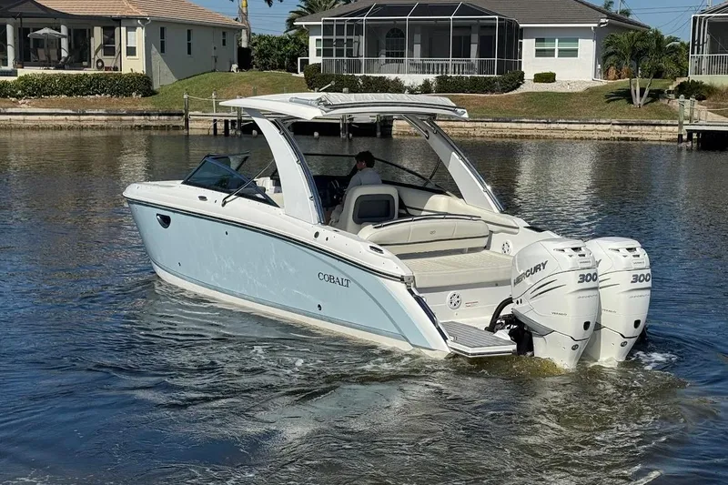 Slide: The Image of 2018 Cobalt 30SC boat with twin Mercury 300 engines on a calm waterway. - 7
