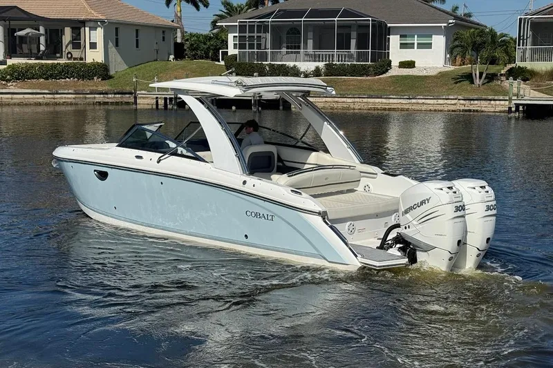 Slide: The Image of 2018 Cobalt 30SC boat with twin Mercury engines on a calm waterway. - 8