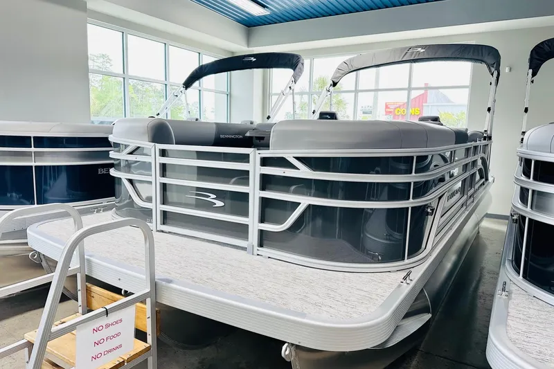 The Image of 2026 Bennington 23 SSR pontoon boat displayed indoors with sleek design and modern features. - 1