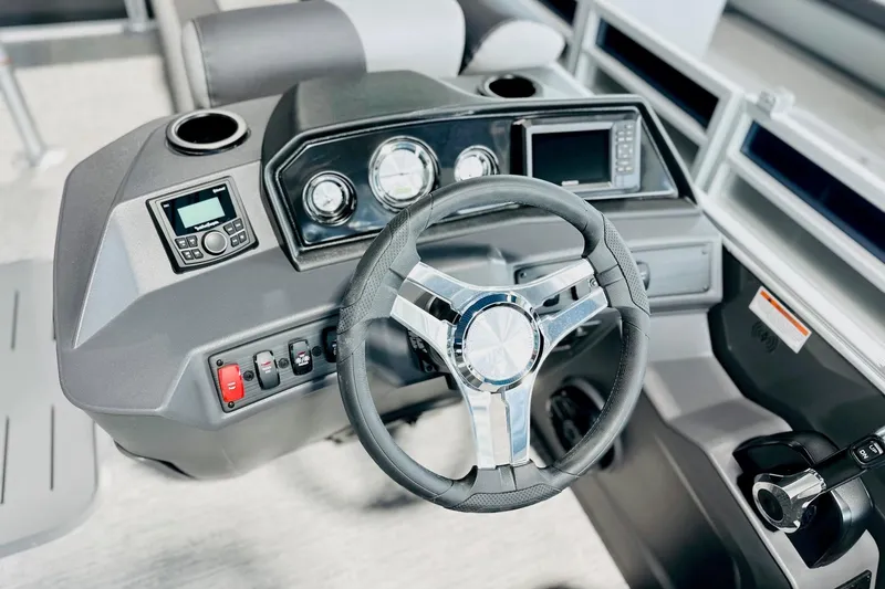 Slide: The Image of 2026 Bennington 23 SSR boat dashboard with steering wheel and control panel. - 2