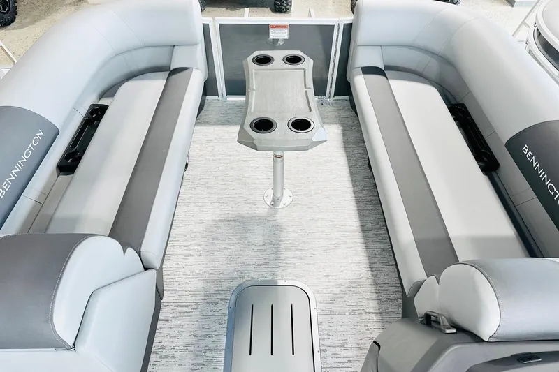 Slide: The Image of 2026 Bennington 23 SSR pontoon boat interior with gray seating and central table. - 7