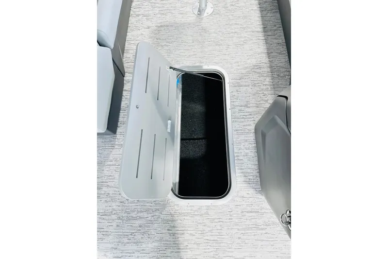 Slide: The Image of Open storage compartment on 2026 Bennington 23 SSR boat with gray flooring. - 9