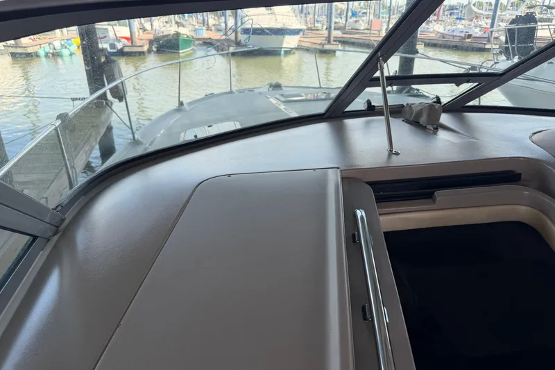 Slide: The Image of Interior view of a 2000 Sea Ray Sundancer 310 boat docked at a marina. - 12