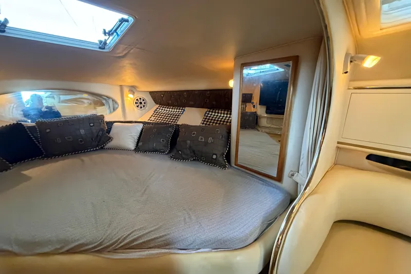 Slide: The Image of Interior cabin of 2000 Sea Ray Sundancer 310 with cozy bedding and cushions. - 14