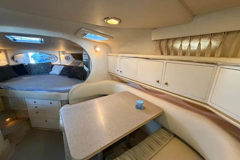 Slide: The Image of Interior of 2000 Sea Ray Sundancer 310 yacht with cozy seating and storage cabinets. - 15