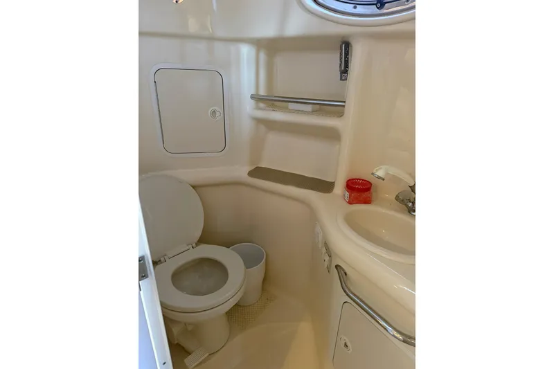 Slide: The Image of Bathroom interior of 2000 Sea Ray Sundancer 310 yacht, featuring toilet and sink. - 17