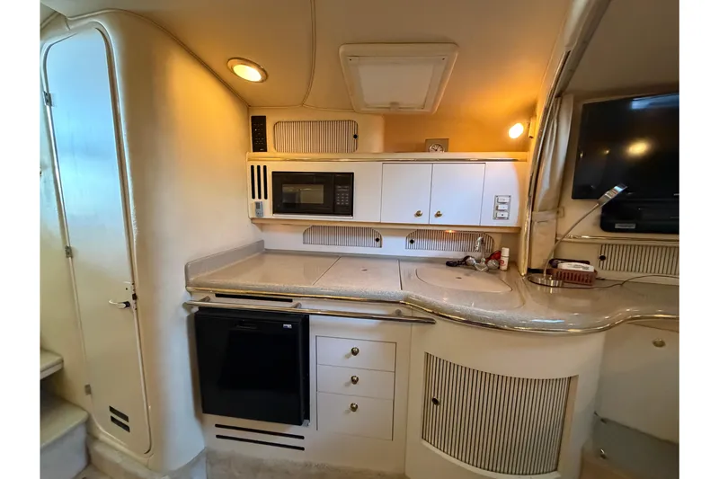 Slide: The Image of Interior of 2000 Sea Ray Sundancer 310 yacht kitchen with modern appliances and cabinetry. - 19