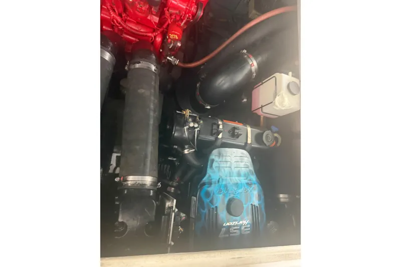 Slide: The Image of Engine compartment of a 2000 Sea Ray Sundancer 310 boat, featuring a custom-painted engine cover. - 21