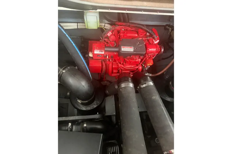 Slide: The Image of Engine compartment of a 2000 Sea Ray Sundancer 310 boat, featuring a red engine. - 22