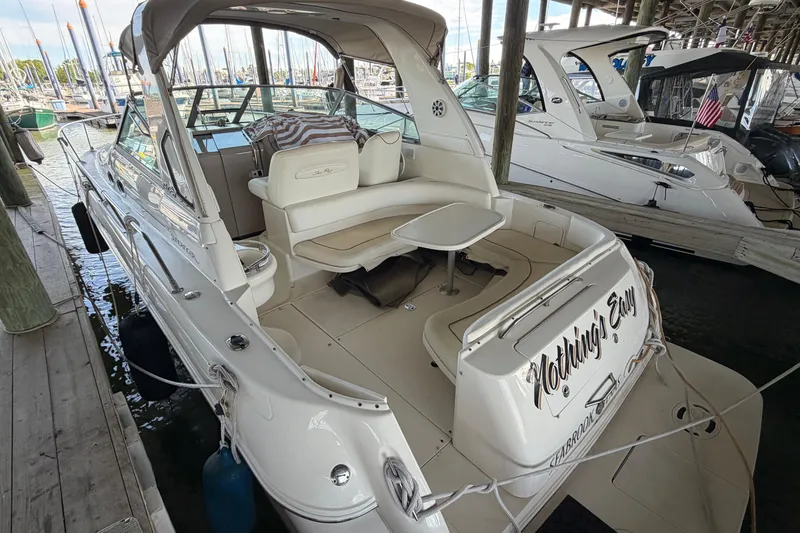 Slide: The Image of 2000 Sea Ray Sundancer 310 docked, featuring spacious seating and elegant design. - 3