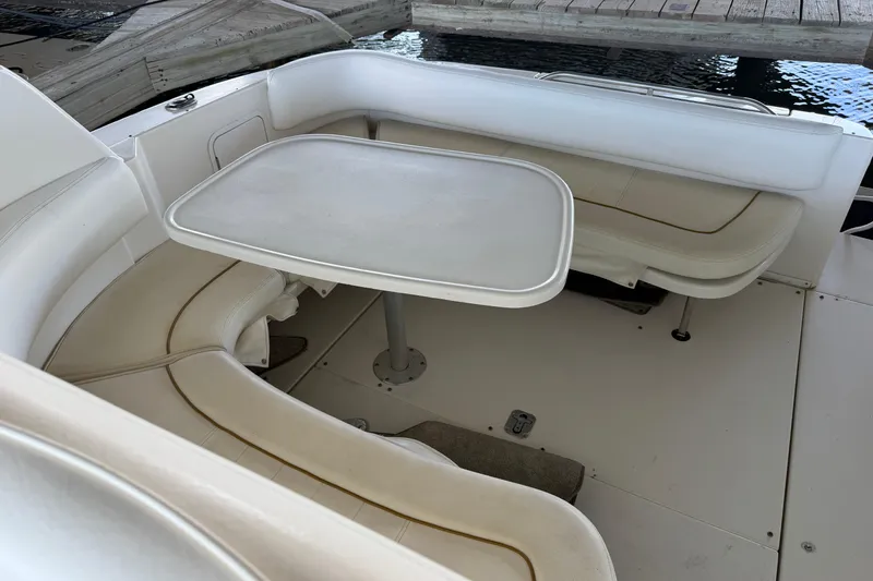 Slide: The Image of Interior seating area of a 2000 Sea Ray Sundancer 310 boat with table. - 6