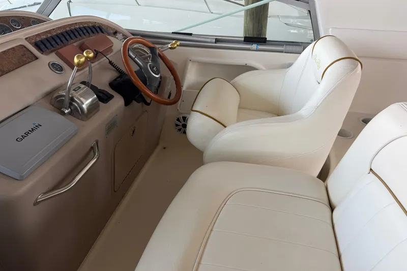 Slide: The Image of Interior of 2000 Sea Ray Sundancer 310 boat with white seating and Garmin navigation system. - 7