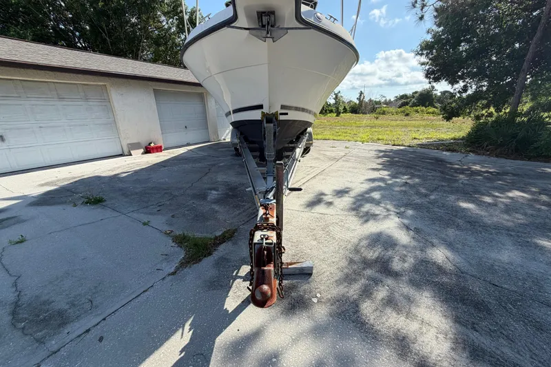 Slide: The Image of Century 3200 Walk-Around boat on trailer, parked in driveway, sunny day. - 10