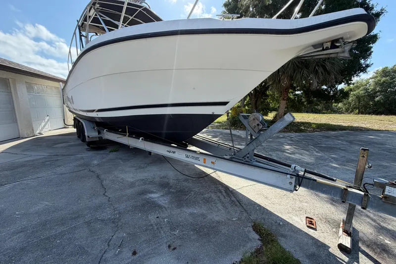 Slide: The Image of Century 3200 Walk-Around boat on trailer, parked outdoors, sunny day. - 11