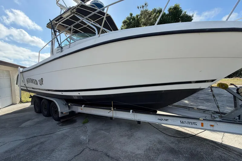 Slide: The Image of Century 3200 Walk-Around 2000 boat on trailer, parked outdoors under blue sky. - 13