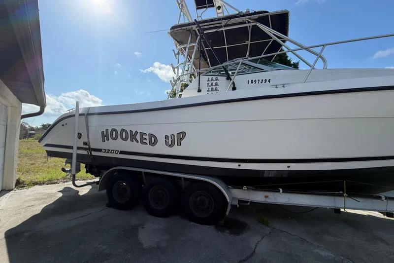 Slide: The Image of Century 3200 Walk-Around boat from 2000 on trailer, named "Hooked Up." - 14