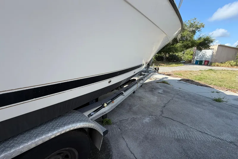 Slide: The Image of Century 3200 Walk-Around boat on trailer, side view, outdoors, sunny day. - 17