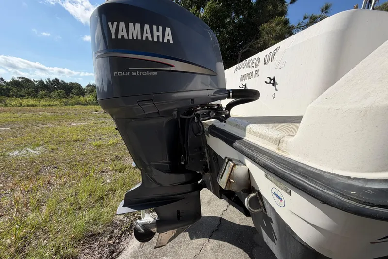 Slide: The Image of Century 3200 Walk-Around 2000 boat with Yamaha four-stroke outboard motor in a grassy area. - 18