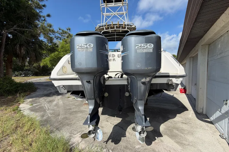 Slide: The Image of Century 3200 Walk-Around 2000 boat with dual Yamaha 250 outboard motors, parked outdoors. - 24