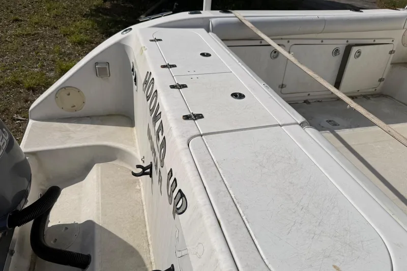 Slide: The Image of Century 3200 Walk-Around 2000 boat deck with storage compartments and visible engine hoses. - 31