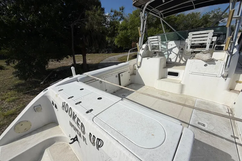 Slide: The Image of Century 3200 Walk-Around 2000 boat with spacious deck and seating, labeled "Hooked Up." - 33