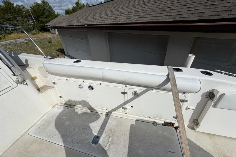 Slide: The Image of 2000 Century 3200 Walk-Around boat deck with storage compartments and railing. - 35