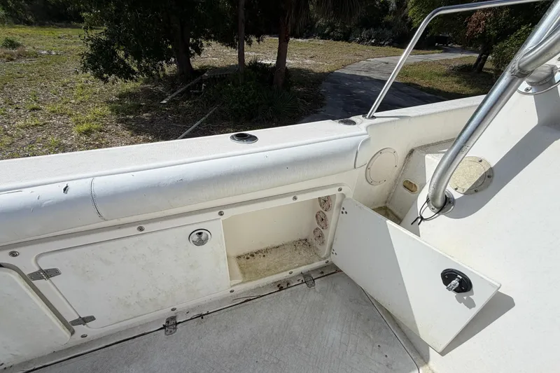 Slide: The Image of 2000 Century 3200 Walk-Around boat interior with open storage compartment. - 37