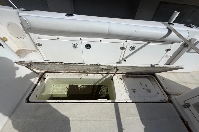 Slide: The Image of Open storage compartment on a 2000 Century 3200 Walk-Around boat, showing interior details. - 38