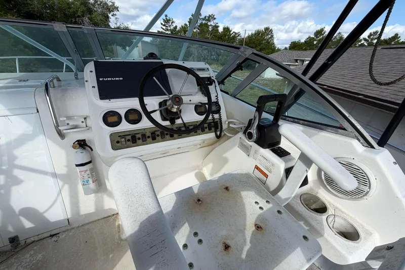 Slide: The Image of Century 3200 Walk-Around 2000 boat cockpit with steering wheel and navigation equipment. - 42