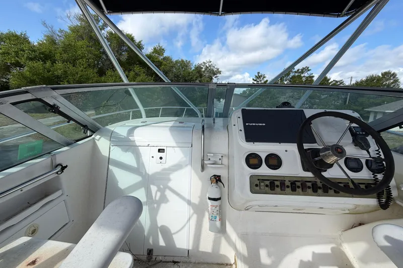 Slide: The Image of Century 3200 Walk-Around 2000 boat cockpit with steering wheel and control panel. - 45