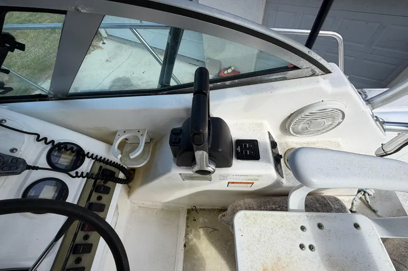 Slide: The Image of Century 3200 Walk-Around 2000 boat cockpit with controls and steering wheel. - 50