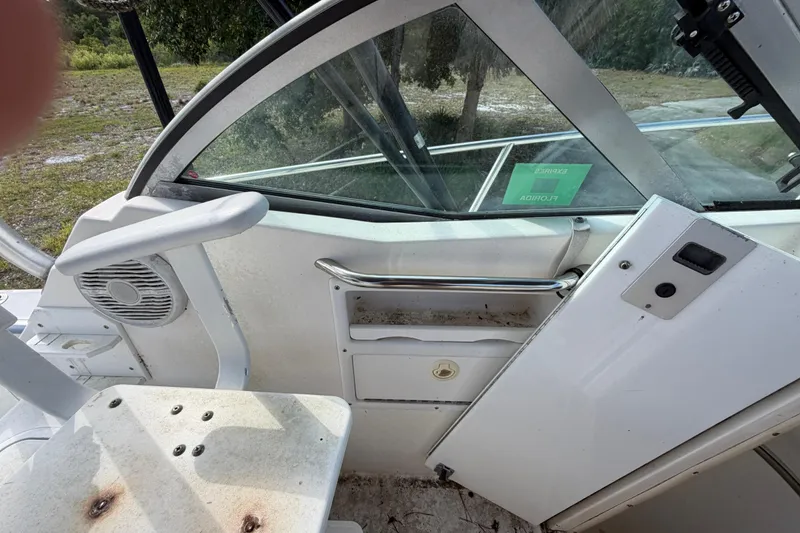 Slide: The Image of Interior view of a 2000 Century 3200 Walk-Around boat, featuring seating and storage. - 51