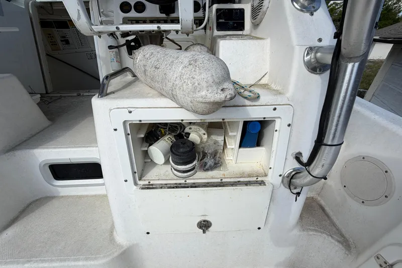 Slide: The Image of 2000 Century 3200 Walk-Around boat storage compartment with marine equipment and accessories. - 52