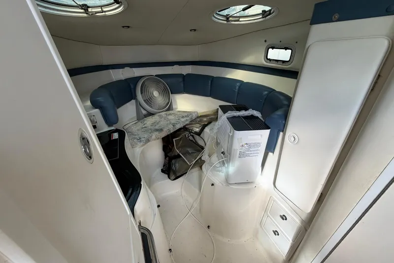 Slide: The Image of Interior of a 2000 Century 3200 Walk-Around boat with seating and appliances. - 53