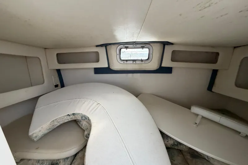 Slide: The Image of Interior cabin of a 2000 Century 3200 Walk-Around boat with seating and storage. - 59