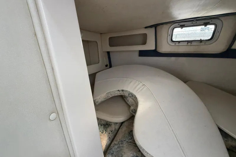 Slide: The Image of Interior cabin of 2000 Century 3200 Walk-Around boat with seating and window. - 60