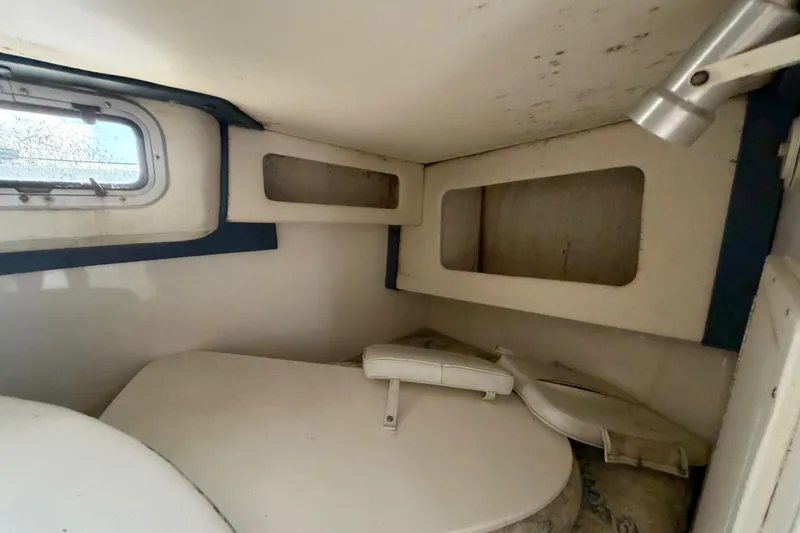 Slide: The Image of Interior cabin of a 2000 Century 3200 Walk-Around boat, featuring a compact design. - 61