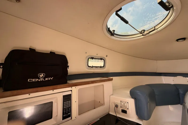 Slide: The Image of Interior of 2000 Century 3200 Walk-Around boat with porthole and seating. - 66