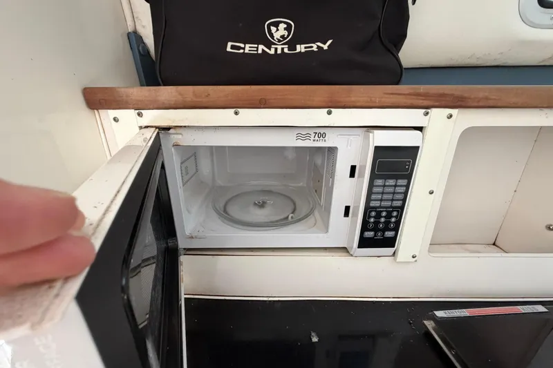Slide: The Image of Microwave inside a 2000 Century 3200 Walk-Around boat, with a Century bag above. - 67