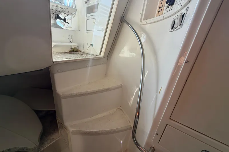 Slide: The Image of Interior stairs of a 2000 Century 3200 Walk-Around boat with metal railing. - 69