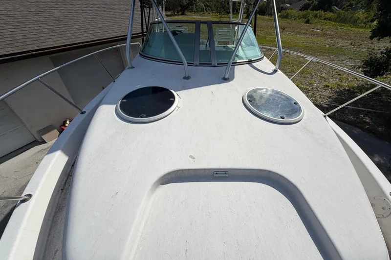 Slide: The Image of Century 3200 Walk-Around 2000 boat deck with hatches and railing in sunlight. - 70