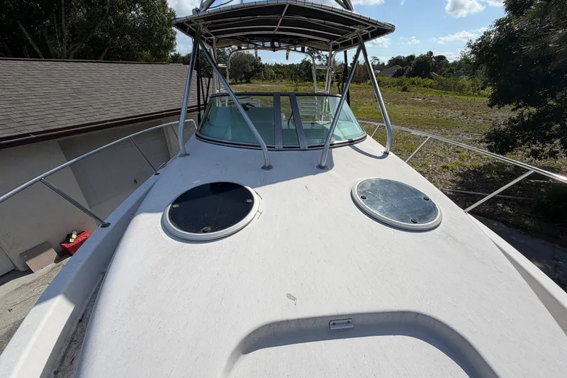 Slide: The Image of 2000 Century 3200 Walk-Around boat deck with hatches and railing, outdoors. - 72