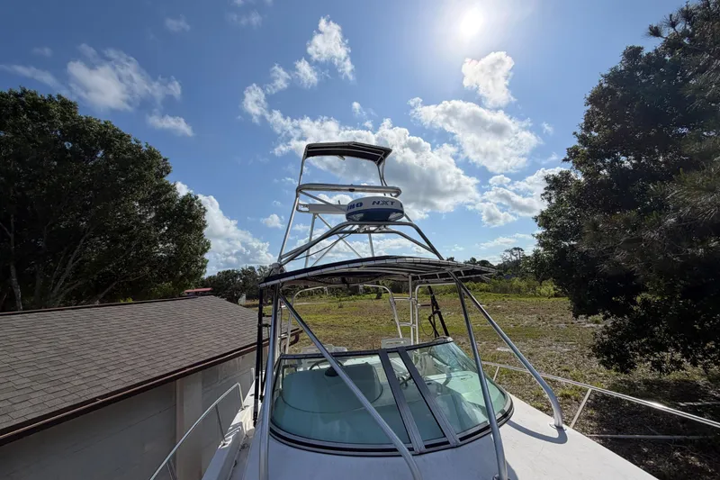 Slide: The Image of Century 3200 Walk-Around boat, 2000 model, parked outdoors under a sunny sky. - 76
