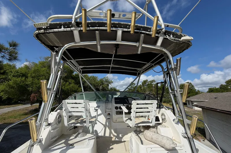 Slide: The Image of 2000 Century 3200 Walk-Around boat interior with seating and fishing rod holders. - 79